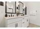 Elegant bathroom with double vanity, black hardware, framed mirrors, and patterned tile flooring at 8718 Sw 139Th Place Rd # 29, Ocala, FL 34473