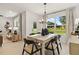Elegant dining area with a stylish table, chandelier, and view of the front yard at 8718 Sw 139Th Place Rd # 29, Ocala, FL 34473