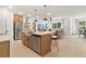 Open-concept kitchen with stainless steel appliances and large island flows into the living area at 8718 Sw 139Th Place Rd # 29, Ocala, FL 34473