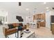 Open concept living room flowing into kitchen with center island and bar stools at 8718 Sw 139Th Place Rd # 29, Ocala, FL 34473