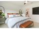Bright main bedroom with a plush bed, stylish decor, and an ensuite bathroom entrance at 8718 Sw 139Th Place Rd # 29, Ocala, FL 34473