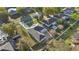 Aerial view of home with covered patio, extended driveway and manicured lawn at 9526 Water Fern Cir, Clermont, FL 34711