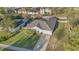 Aerial view of a single-story home with a well-manicured lawn and a long driveway at 9526 Water Fern Cir, Clermont, FL 34711