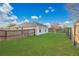 Spacious, fenced back yard with lush green grass, perfect for recreation and outdoor gatherings at 9526 Water Fern Cir, Clermont, FL 34711