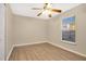 Bedroom with wood floor and a ceiling fan providing a cozy and stylish living space at 9526 Water Fern Cir, Clermont, FL 34711