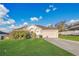 Charming single-story home features a well-maintained lawn and attached two-car garage at 9526 Water Fern Cir, Clermont, FL 34711