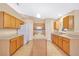 Bright kitchen with oak cabinets, an island, and tile flooring at 9526 Water Fern Cir, Clermont, FL 34711