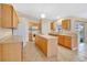 Spacious kitchen features oak cabinets, an island, and modern appliances at 9526 Water Fern Cir, Clermont, FL 34711
