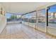 Spacious screened-in porch with tiled floors, providing an ideal indoor-outdoor living space at 9526 Water Fern Cir, Clermont, FL 34711