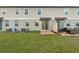Backyard with lush green lawn, sliding glass doors, and patio area at 987 Desert Candle Dr, Ocoee, FL 34761