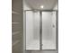 Modern bathroom featuring a sleek glass shower with white tiled walls and a built-in shower head at 987 Desert Candle Dr, Ocoee, FL 34761