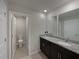 Bathroom featuring a double sink vanity with granite countertops and modern fixtures at 987 Desert Candle Dr, Ocoee, FL 34761