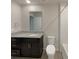 Bathroom features granite countertop, dark cabinets, white tile, and a toilet at 987 Desert Candle Dr, Ocoee, FL 34761