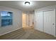 A bright bedroom featuring neutral walls, carpeted floor, window with blinds, and double door closet at 987 Desert Candle Dr, Ocoee, FL 34761