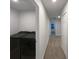Hallway view showcasing the laundry room, neutral walls, carpeted floor, and white doors at 987 Desert Candle Dr, Ocoee, FL 34761
