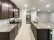 Kitchen boasts granite counters, stainless appliances, and tiled floors at 987 Desert Candle Dr, Ocoee, FL 34761