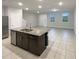 Kitchen with granite island, stainless appliances, and open floor plan at 987 Desert Candle Dr, Ocoee, FL 34761