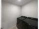 This laundry room features a modern, black Samsung washer and dryer set at 987 Desert Candle Dr, Ocoee, FL 34761