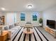 Living room with stylish rug, modern furniture, and bright natural light at 987 Desert Candle Dr, Ocoee, FL 34761