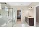 Bathroom with glass enclosed shower, vanity with granite countertop and view to the bedroom at 10732 Petrillo Way, Winter Garden, FL 34787