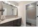 Well-lit bathroom features a granite countertop, a large mirror, and a shower-tub combination at 10732 Petrillo Way, Winter Garden, FL 34787