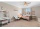 Serene bedroom with a window offering natural light and decorated with a vanity and a comforting decor at 10732 Petrillo Way, Winter Garden, FL 34787
