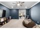Cozy media room provides a lounge area with a large TV and a glimpse of the bonus room next door at 10732 Petrillo Way, Winter Garden, FL 34787