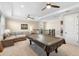 Spacious bonus room with ample lighting, large sectional sofa, and a pool table, perfect for entertainment at 10732 Petrillo Way, Winter Garden, FL 34787