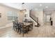 Dining room with wood table and chairs and staircase at 10732 Petrillo Way, Winter Garden, FL 34787