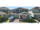 Charming two-story home with a welcoming front porch, manicured landscaping, and a two-car garage at 10732 Petrillo Way, Winter Garden, FL 34787