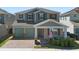 Charming two-story home with a brick driveway, covered porch, and manicured landscaping at 10732 Petrillo Way, Winter Garden, FL 34787