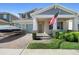 Charming front exterior of a two-story home with a two-car garage, and a well-manicured lawn with an American flag at 10732 Petrillo Way, Winter Garden, FL 34787