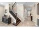 Inviting entry foyer with hardwood floors and staircase featuring dark wood trim and iron balusters at 10732 Petrillo Way, Winter Garden, FL 34787