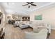 Spacious living room with tile floors, ceiling fan, and furniture at 10732 Petrillo Way, Winter Garden, FL 34787