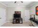 Cozy living room with carpet, media center with storage and display shelves, and two doors at 10732 Petrillo Way, Winter Garden, FL 34787