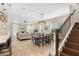 Open-concept living space with tile floors, recessed lights, dining area, and a staircase at 10732 Petrillo Way, Winter Garden, FL 34787