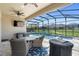 Screened in patio area with outdoor dining set, grill, tv, and view of the swimming pool and yard at 10732 Petrillo Way, Winter Garden, FL 34787