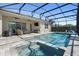 Backyard view of the screened-in pool and hot tub with patio and backyard seating at 10732 Petrillo Way, Winter Garden, FL 34787