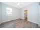 Bedroom with an en suite bathroom, ceiling fan, hardwood floors, and a window with lots of natural light at 1104 Grove Manor Dr, Sanford, FL 32771