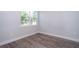 Cozy bedroom with hardwood floors, base trim, and a bright window with a view at 1104 Grove Manor Dr, Sanford, FL 32771