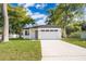 Charming single-story home featuring a well-manicured lawn, neutral paint scheme and a two-car garage at 1104 Grove Manor Dr, Sanford, FL 32771