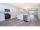 Bright kitchen boasts stainless steel appliances, quartz countertops, and an island with a sink at 1104 Grove Manor Dr, Sanford, FL 32771