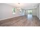 Spacious open-concept living area with hardwood flooring, natural light, and sliding glass door to backyard at 1104 Grove Manor Dr, Sanford, FL 32771