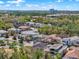 An aerial view showing the neighborhood and local landmarks, surrounded by lush green foliage at 1281 Grand Traverse Pkwy, Reunion, FL 34747
