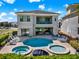 Stunning backyard featuring a pool, two hot tubs, ample seating, and manicured landscaping at 1281 Grand Traverse Pkwy, Reunion, FL 34747