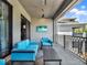 Comfortable balcony featuring gray stone floors, black railings, and modern furniture at 1281 Grand Traverse Pkwy, Reunion, FL 34747
