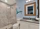 Themed bathroom featuring a glass shower, vanity, and themed design at 1281 Grand Traverse Pkwy, Reunion, FL 34747
