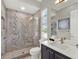 Modern bathroom featuring a glass shower and a vanity with a mirror at 1281 Grand Traverse Pkwy, Reunion, FL 34747