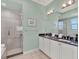 Bathroom featuring a large glass shower, dual sink vanity, and calm colors at 1281 Grand Traverse Pkwy, Reunion, FL 34747