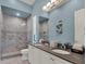 Double vanity bathroom with walk-in shower and tiled floors, offering a modern and stylish space at 1281 Grand Traverse Pkwy, Reunion, FL 34747